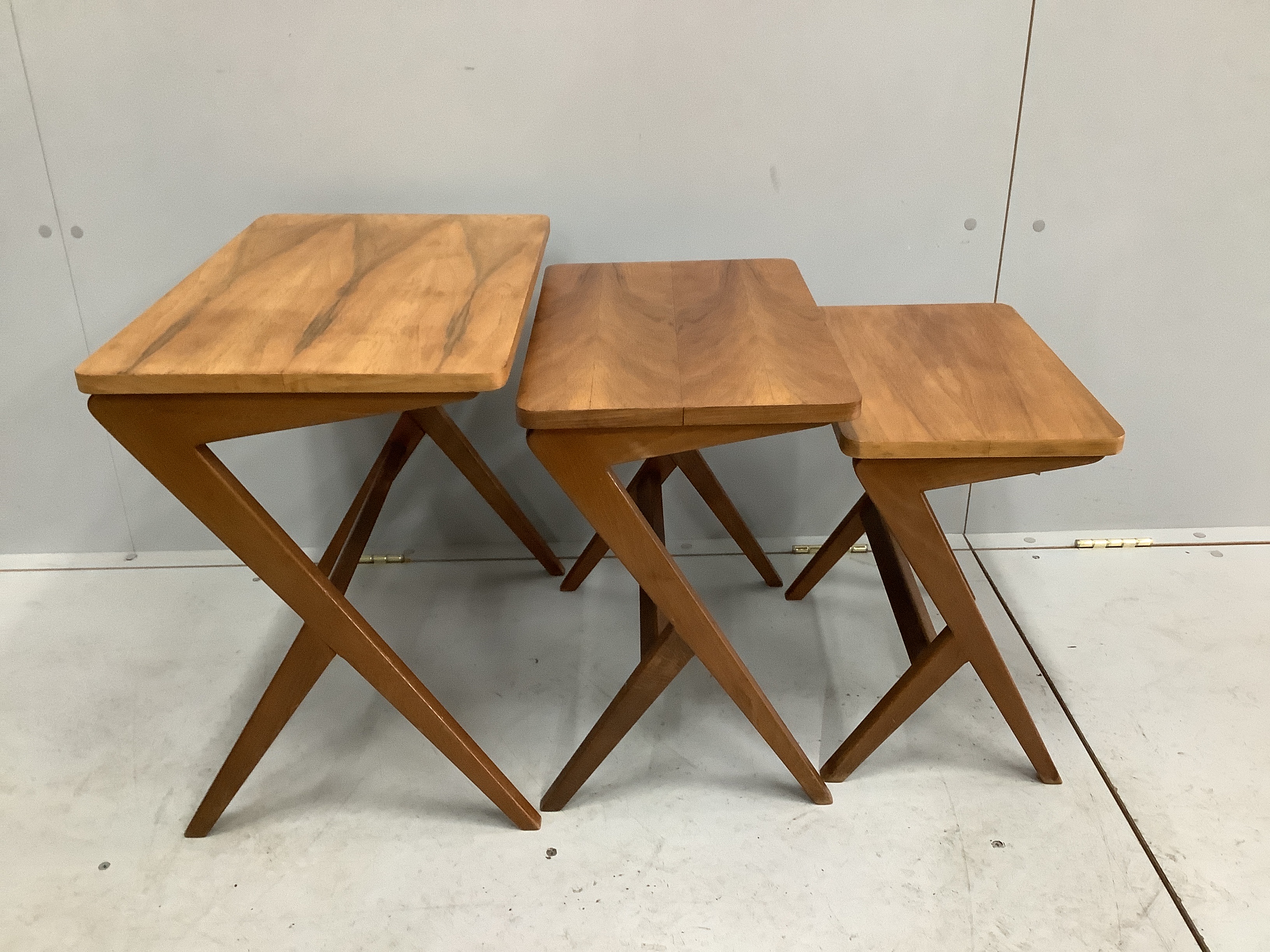 A nest of three beech and walnut rectangular designed by Bengt Ruda 'Walking' nest of tables, width 54cm, depth 35cm, height 49cm